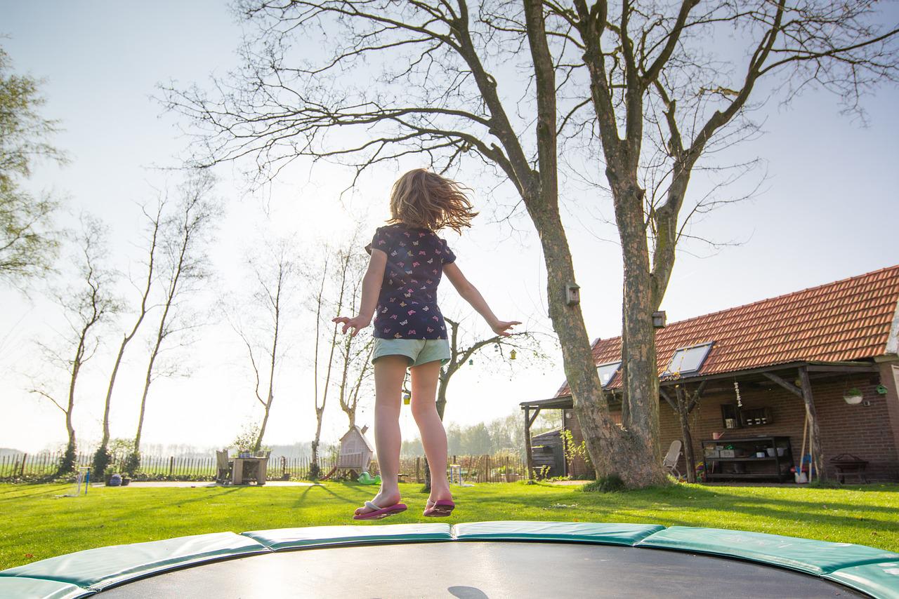 kid jumping on a trampoline