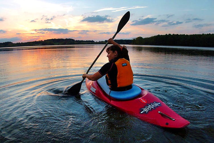 girl riding a kayak in a lake