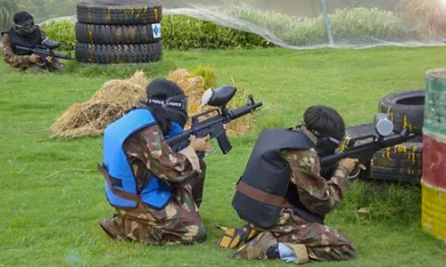 girls playing paintball with gun