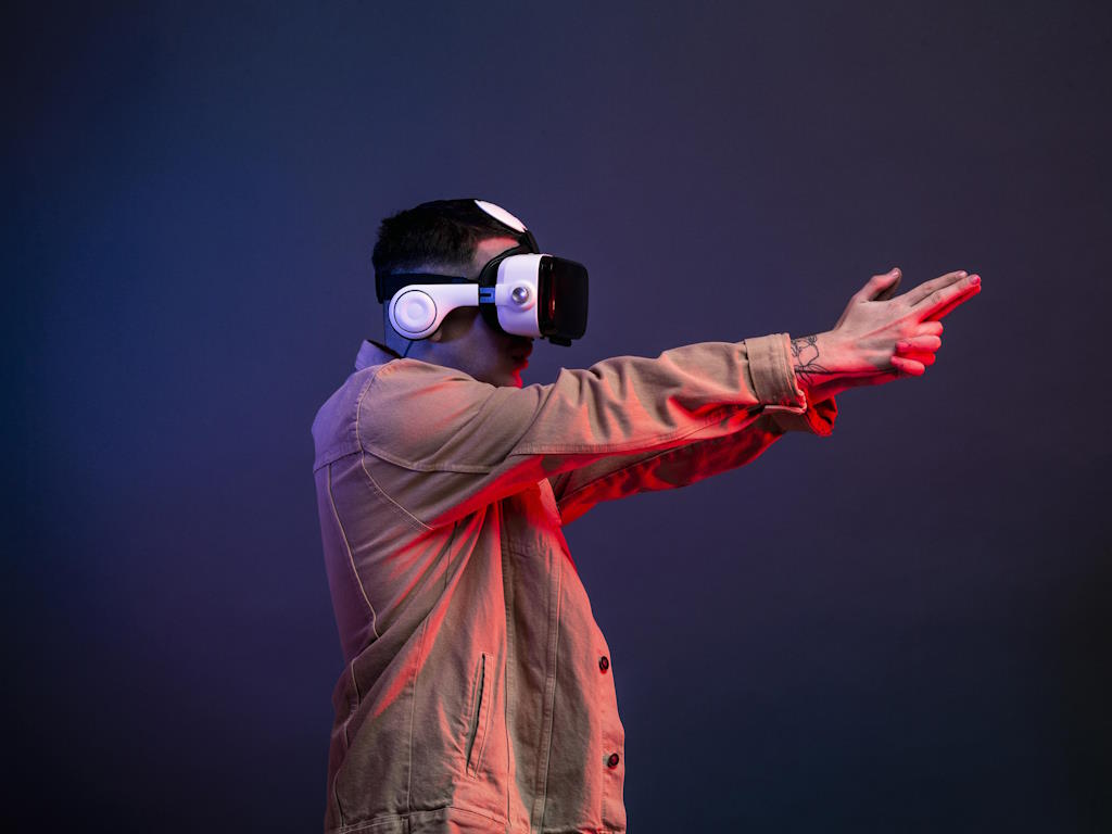 man wearing vr goggles shooting game