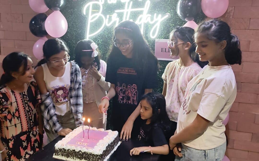 Children gather around a birthday cake in a festive setting, celebrating at a venue in Banjara Hills, ideal for escape room activities and mystery games.