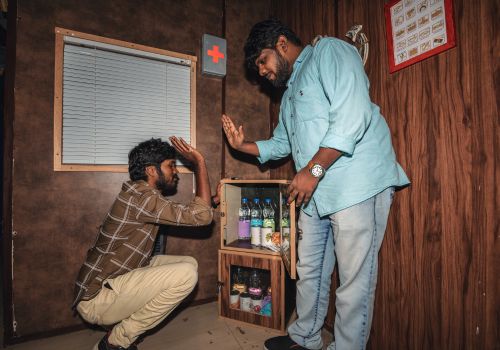 Two teammates celebrating a successful puzzle solve during a team-building escape room challenge at Lock N Escape.