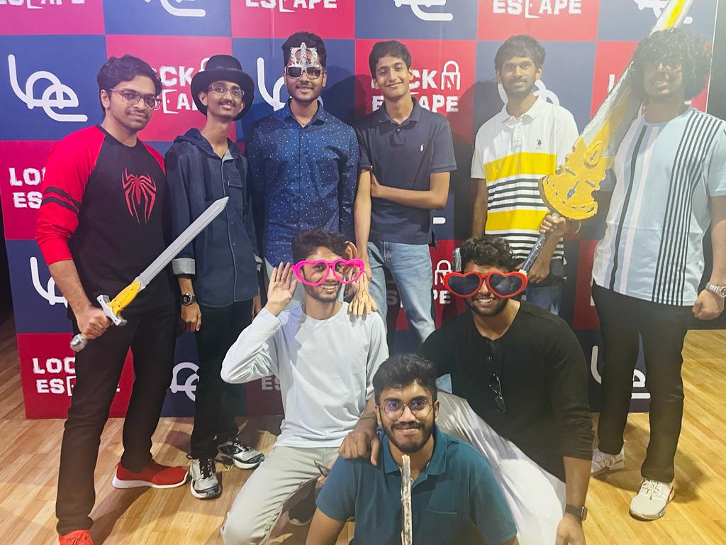 Escape Rooms & Indoor Team-Building Games in Hyderabad — group of friends posing with props at Lock N Escape Banjara Hills after completing an escape room challenge