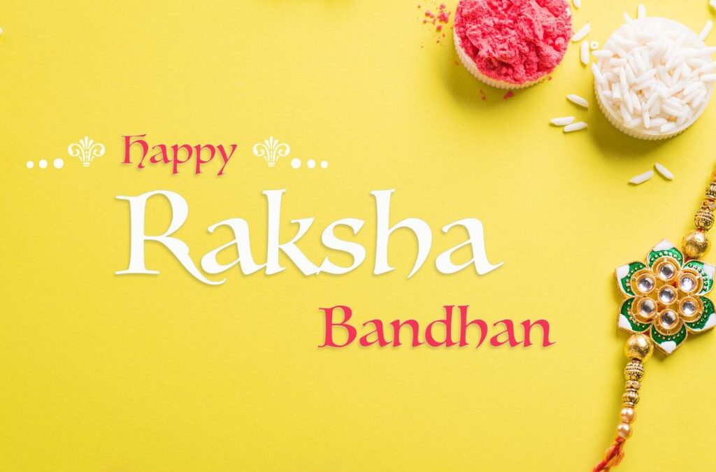 Decorative rakhi with kumkum and rice on a yellow background with Happy Raksha Bandhan text, representing the best rakhi gift ideas in Hyderabad from Lock N Escape