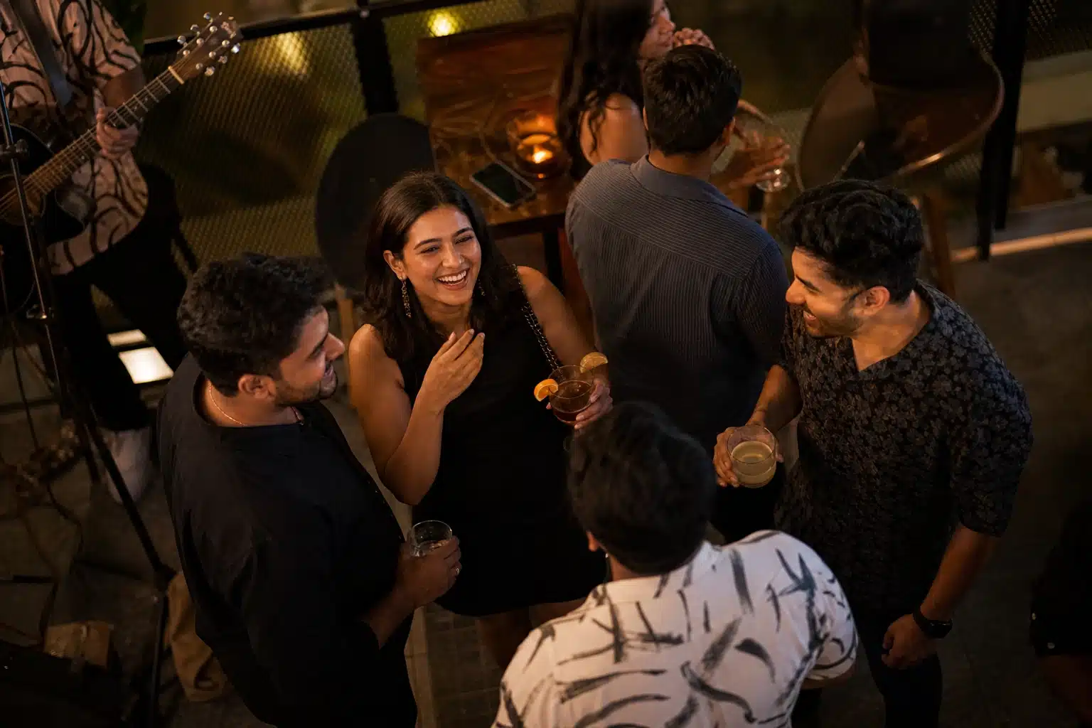 People enjoying cocktails and music.